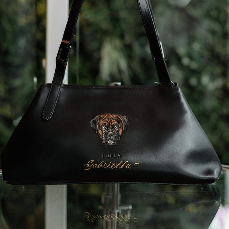 Hand-painted Boxer dog portrait on a vintage Furla leather handbag by Aivis Provejs, bespoke luxury pet portrait and leather personalisation.