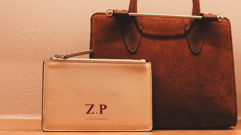 Personalised Strathberry leather pouch with hand-painted monogram initials by Aivis Provejs, bespoke luxury leather personalisation and gifting.