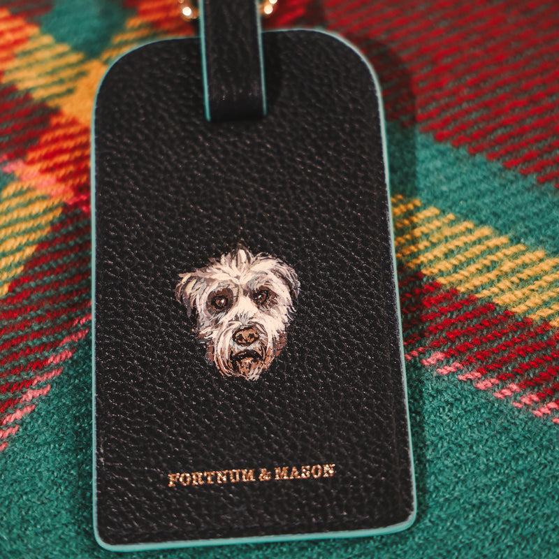 Fortnum & Mason leather luggage tag featuring a hand-painted dog portrait, showcasing bespoke luxury leather personalisation and custom pet artwork by Aivis Provejs.