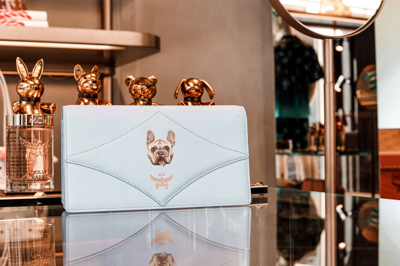 Hand-painted French Bulldog portrait on an MCM leather wallet by Aivis Provejs, bespoke luxury pet portrait and leather personalisation.