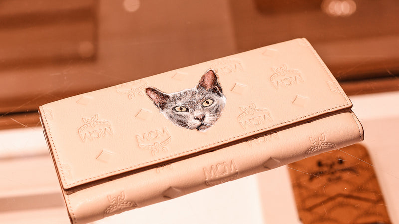 MCM leather wallet featuring a hand-painted cat portrait, showcasing bespoke luxury leather personalisation and custom pet artwork by Aivis Provejs.